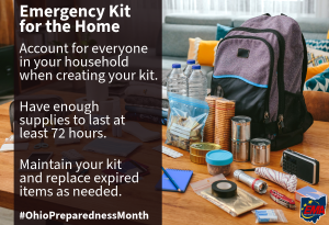 A household emergency kit with a backpack, bottled water, canned food, flashlight, batteries, first aid supplies, and other essentials is displayed on a table. Text offers tips for preparing a home emergency kit. #OhioPreparednessMonth.